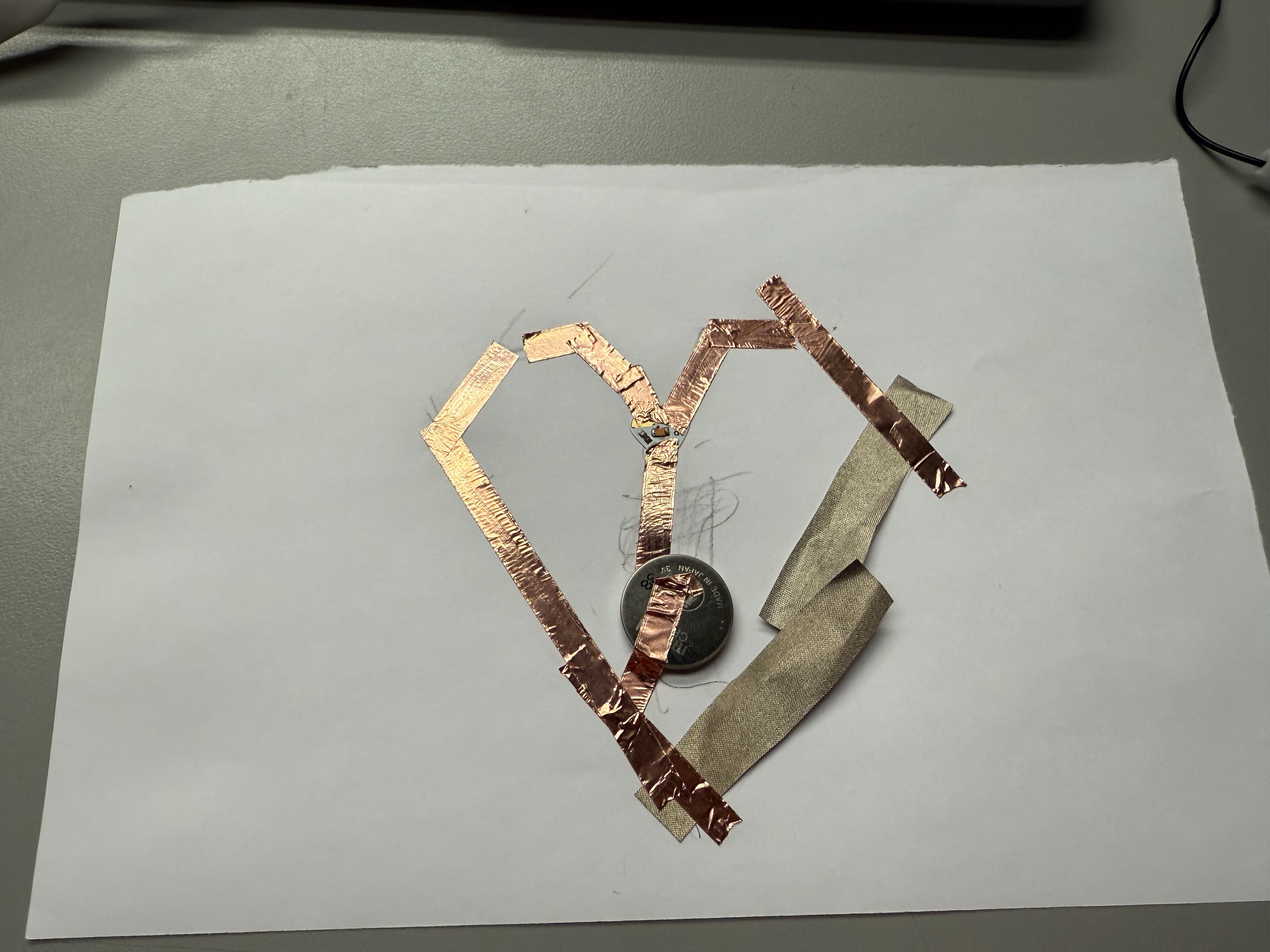 Detailed view of copper tape connections in a led heart circuit.