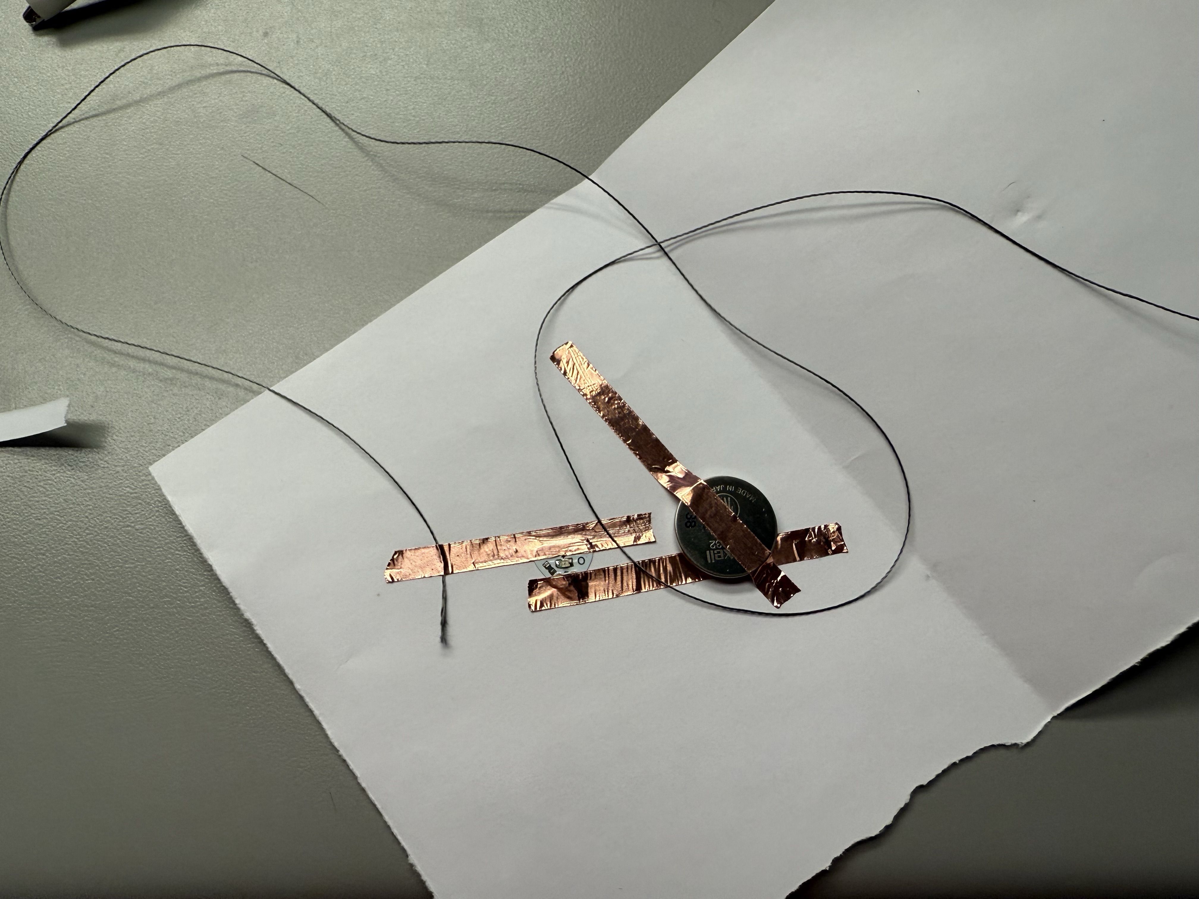 Step-by-step assembly of a small circuit using copper tape+Conductive thread and fabric and LEDs.
