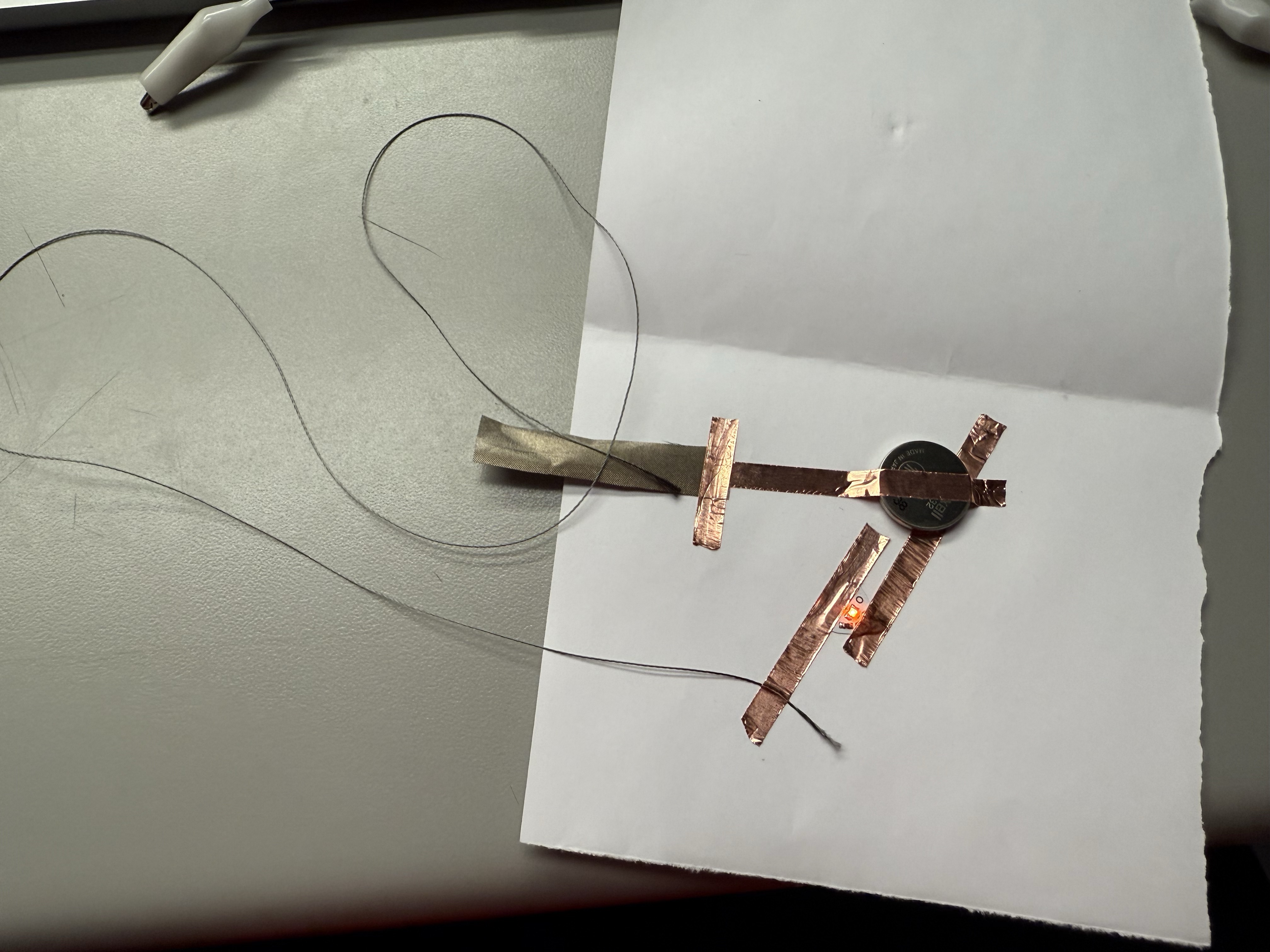 Detailed view of copper tape+Conductive thread and fabric connections in a circuit.