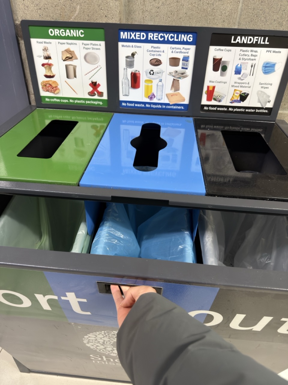 pulling a drawer open to reveal its contents.