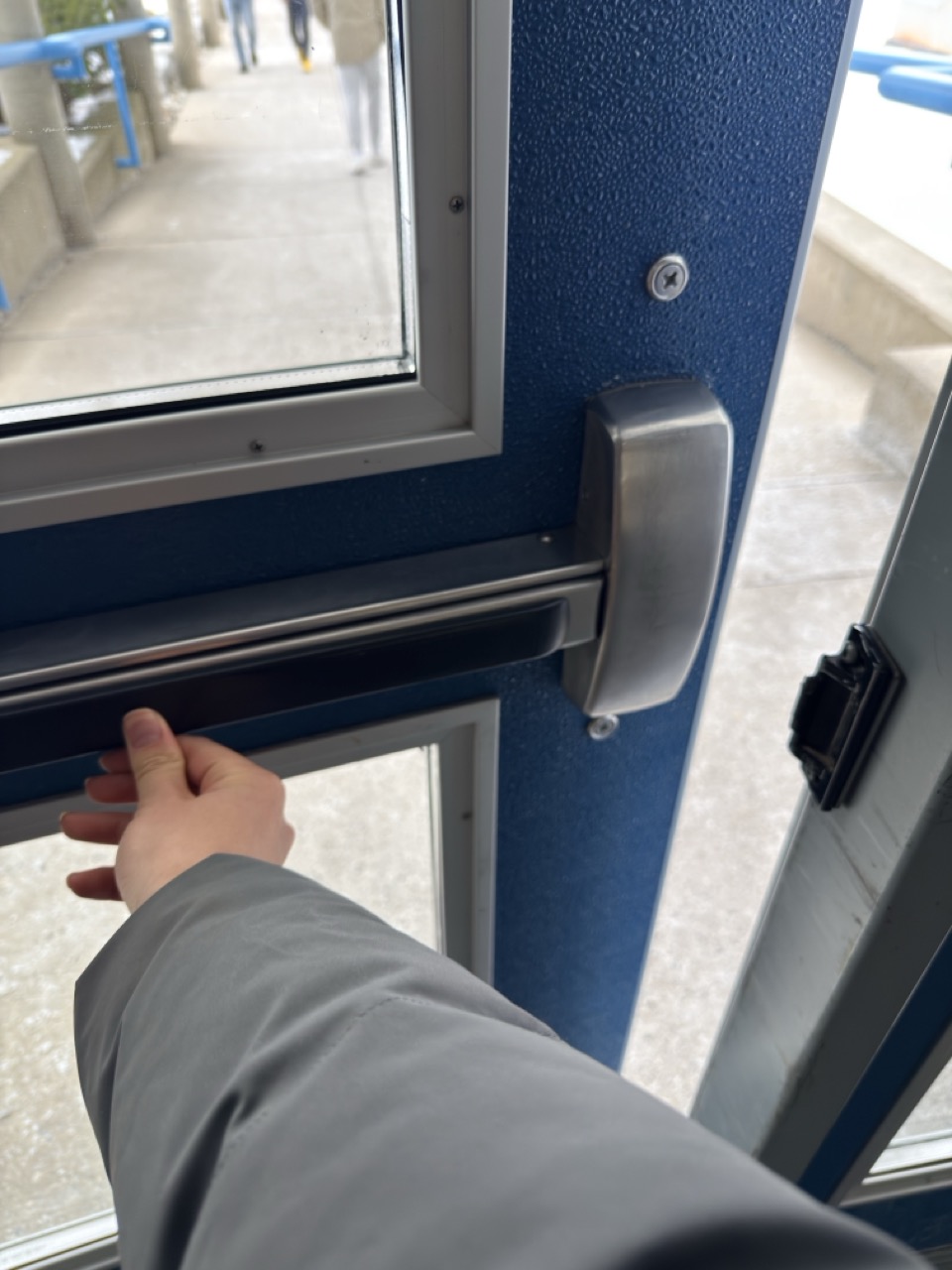 A hand pulling a lever on a manual device to activate it.